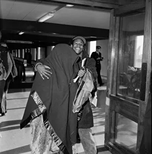 01159 Gallery: American pop artist Prince leaving Britain with a blanket over his head