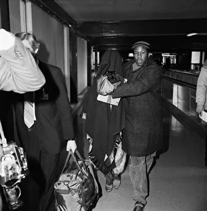 Images Dated 12th February 1985: American pop artist Prince leaving Britain with a blanket over his head