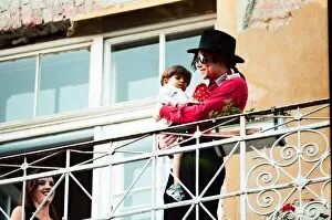 Images Dated 8th August 1994: American pop singer Michael Jackson with young orphan Bela Farkas posing on a hotel