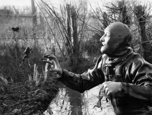Images Dated 17th February 1971: Animals: Frogs. Frogman Bill trying to catch jumping frogs in his back garden