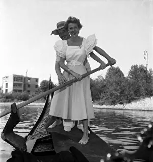 00020 Gallery: Ann French, actress posing with a gondolier in Venice, Italy. September 1952 C4555