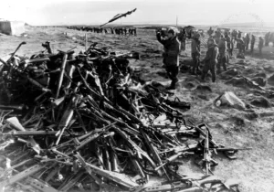 ARGENTINE SOLDIERS THROWING THEIR WEAPONS ONTO A PILE AT PORT STANLEY AFTER SURRENDERING ARGENTINE SOLDIERS THROWING THEIR WEAPONS ONTO A PILE AT PORT STANLEY AFTER SURRENDERING