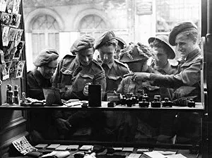 00492 Gallery: Army Soldiers looking through a shop window - June 1944 for souvenirs to send back home