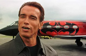 Arnold Schwarzenegger arrives at Luton Airport with wife Maria in Batplane Arnold Schwarzenegger arrives at Luton Airport with wife Maria in Batplane