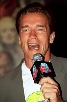 Images Dated 1st July 1998: Arnold Schwarzenger Actor July 98 At Planet Hollywood restaurant in london holding