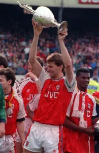 Arsenal captain Tony Adams lifts the League Championship trophy after they defeated Arsenal captain Tony Adams lifts the League Championship trophy after they defeated