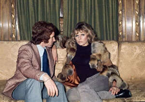 Images Dated 23rd February 1972: Arsenal footballer Alan Ball sitting on a sofa talking to actress June Ege during a team