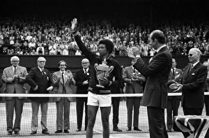 Images Dated 5th July 1975: Arthur Ashe receives the trophy from the Duke of Kent after he defeated the defending