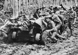 Australian-made 25 pounder being manhandled through the mud at Langemak Bay New Guinea Australian-made 25 pounder being manhandled through the mud at Langemak Bay New Guinea