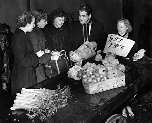 Barrow boys gives away vegetables to women. August 1954 P009856 Barrow boys gives away vegetables to women. August 1954 P009856