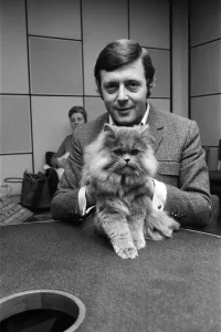 BBC commentator Michael Aspel at the BBC Studios at Lancaster Gate with a cat who is a BBC commentator Michael Aspel at the BBC Studios at Lancaster Gate with a cat who is a