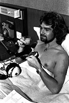 Images Dated 1st October 1977: BBC Radio One DJ Noel Edmonds doing his breakfast radio show from his bed at the Centre