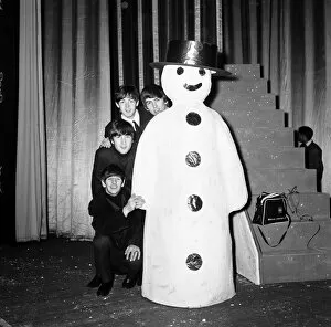 Images Dated 25th January 2013: The Beatles pose with a Snowman, as they take a break from rehearsals at the Astoria