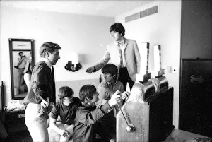 Beatles press officer, Derek Taylor, digs into his pocket for coins as the Beatles play Beatles press officer, Derek Taylor, digs into his pocket for coins as the Beatles play