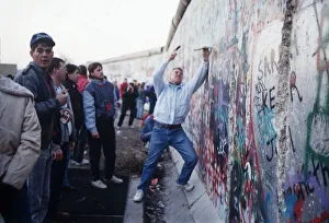 Berlin Wall souvenir hunter chip at the wall for memorabilia before it is demolished Berlin Wall souvenir hunter chip at the wall for memorabilia before it is demolished