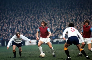 Billy Bonds of West Ham United in a battle for the ball with Archie Gemmill of Derby
