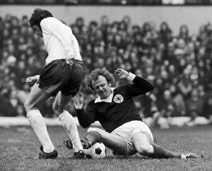 Billy Bremner in action against a un-named English player during Scotland'