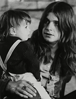 Images Dated 30th March 2005: Black Sabbath lead singer Ozzy Osbourne holding his 22 month old daughter Jessica