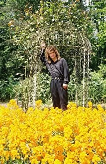Images Dated 27th May 1988: Black Sabbath singer Ozzy Osbourne amongst the flowers in the garden of his home