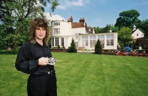 Images Dated 27th May 1988: Black Sabbath singer Ozzy Osbourne holding a cup of tea in the garden of his home