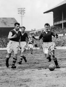 Blunstone (right) the Chelsea outside left, dribbles the ball past Rudman Blunstone (right) the Chelsea outside left, dribbles the ball past Rudman