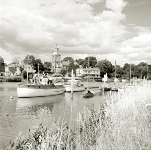 Boats sailing along a river while long grass grows on the bank beside Circa 1955 Boats sailing along a river while long grass grows on the bank beside Circa 1955