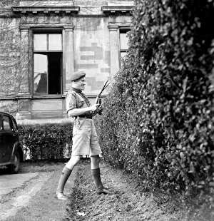 Bob-a-job week April 1953. John Jackson, boy scout seen here cutting the hedge of Bob-a-job week April 1953. John Jackson, boy scout seen here cutting the hedge of