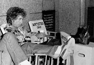 Bob Dylan American singer songwriter with his feet up on a film set for Hearts of Desire