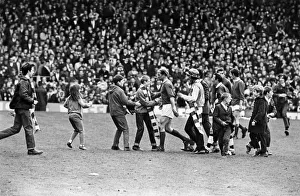 Bobby Charlton leaving the pitch at Old Trafford with young fans rushing to shake his Bobby Charlton leaving the pitch at Old Trafford with young fans rushing to shake his