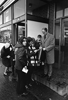 Bobby Charlton is met by autograph hunters as he leaves Old Trafford for London
