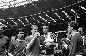 Bobby Charlton with sponge and Noel Cantwell holding the trophy after beating Leicester Bobby Charlton with sponge and Noel Cantwell holding the trophy after beating Leicester
