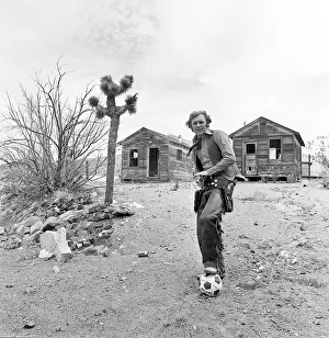 Bobby Moore poses for the camera dressed as Cowboy when the West Ham team were on a close Bobby Moore poses for the camera dressed as Cowboy when the West Ham team were on a close
