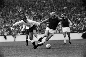 Bobby Moore of West Ham is tripped by Tottenham Hotspur forward Jimmy Greaves during Bobby Moore of West Ham is tripped by Tottenham Hotspur forward Jimmy Greaves during