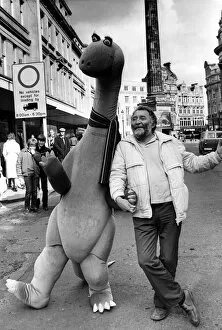 Images Dated 26th March 1983: Botanist David Bellamy with a pink brontosaurus in Newcastle city centre on 26th March