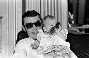 Images Dated 13th April 1977: Boxer Alan Minter pictured at his Crawley Sussex home with his six month old baby