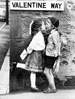 School Uniform Collection: Boy holding flowers behind his back kisses on Valentines Day