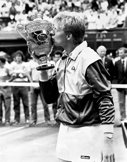 Boy king Boris Becker plants a smacker on the championship trophy Boy king Boris Becker plants a smacker on the championship trophy