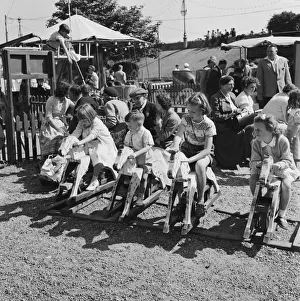 Boys and girls playing on the rocking horses at a children's playground in Southend Boys and girls playing on the rocking horses at a children's playground in Southend