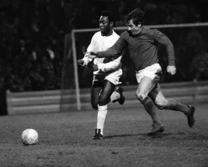Brazilian football star Pele of Santos chases for the ball with Alan Mullery of Fulham Brazilian football star Pele of Santos chases for the ball with Alan Mullery of Fulham