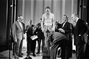 Britain's Henry Cooper weighs-in for his non title bout against Cassius Clay aka Britain's Henry Cooper weighs-in for his non title bout against Cassius Clay aka