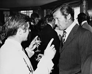 Images Dated 14th July 1970: British actor Roger Moore July 1970 chatting with Bryan Forbes Associated