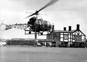 A British Army Westland Sioux helicopter dropped into the car park at the Jingling Gate