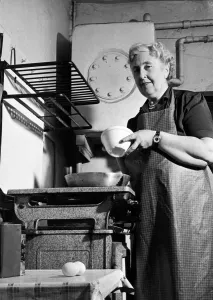 Jon Scan Gallery: British author Agatha Christie pictured cooking in the kitchen at her home at Winterbrook