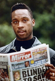 British boxer Nigel Benn with a copy of the Daily Mirror. 3rd July 1992