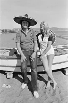 British darts player Eric Bristow poses with Maureen Flowers on the beach at Torremolinos