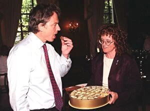 Images Dated 29th July 1999: British Prime Minister Tony Blair accepts a chocolate from Judy Mallaber MP for Amber