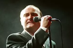 Images Dated 13th March 1990: British singer Phil Collins performing on stage during a concert in Britain