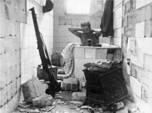 Libya Collection: A British solder having a bath. Tobruk. Libya. The Siege of Tobruk lasted