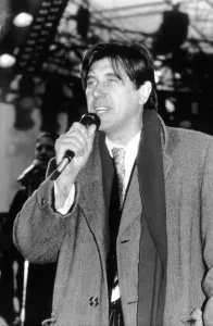 Bryan Ferry Singer with Pop Group Roxy Music singing on stage wearing overcoat and scarf Bryan Ferry Singer with Pop Group Roxy Music singing on stage wearing overcoat and scarf