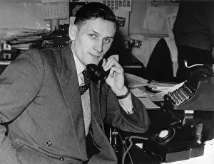 Business man talking on the telephone as he sits at a desk. Circa 1940 Business man talking on the telephone as he sits at a desk. Circa 1940